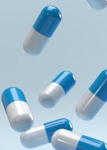 Falling,pills,on,a,blue,background.,antibiotics.,3d,render.