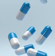 Falling,pills,on,a,blue,background.,antibiotics.,3d,render.